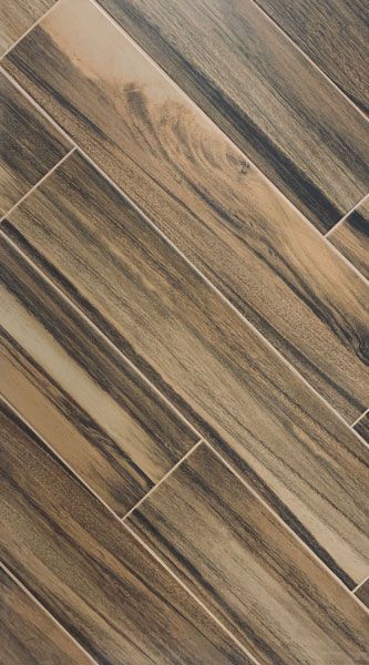 A close up of a tile floor that looks like wood.