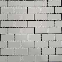 A close up of a white brick wall with black lines.