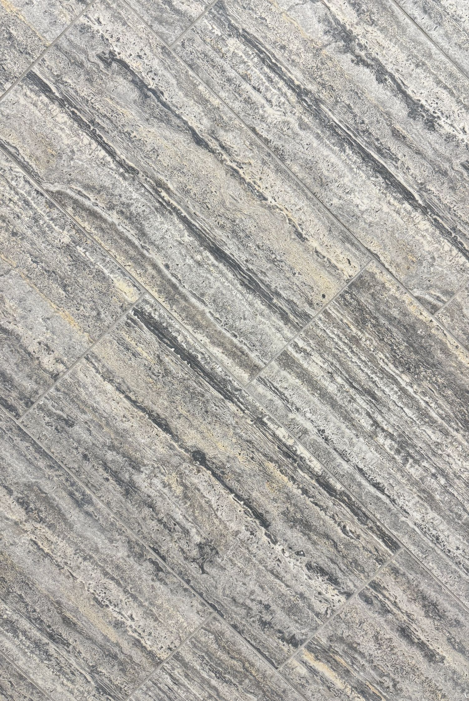 A close up of a concrete surface with a diagonal pattern.