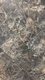 A close up of a marble floor with a diagonal pattern.