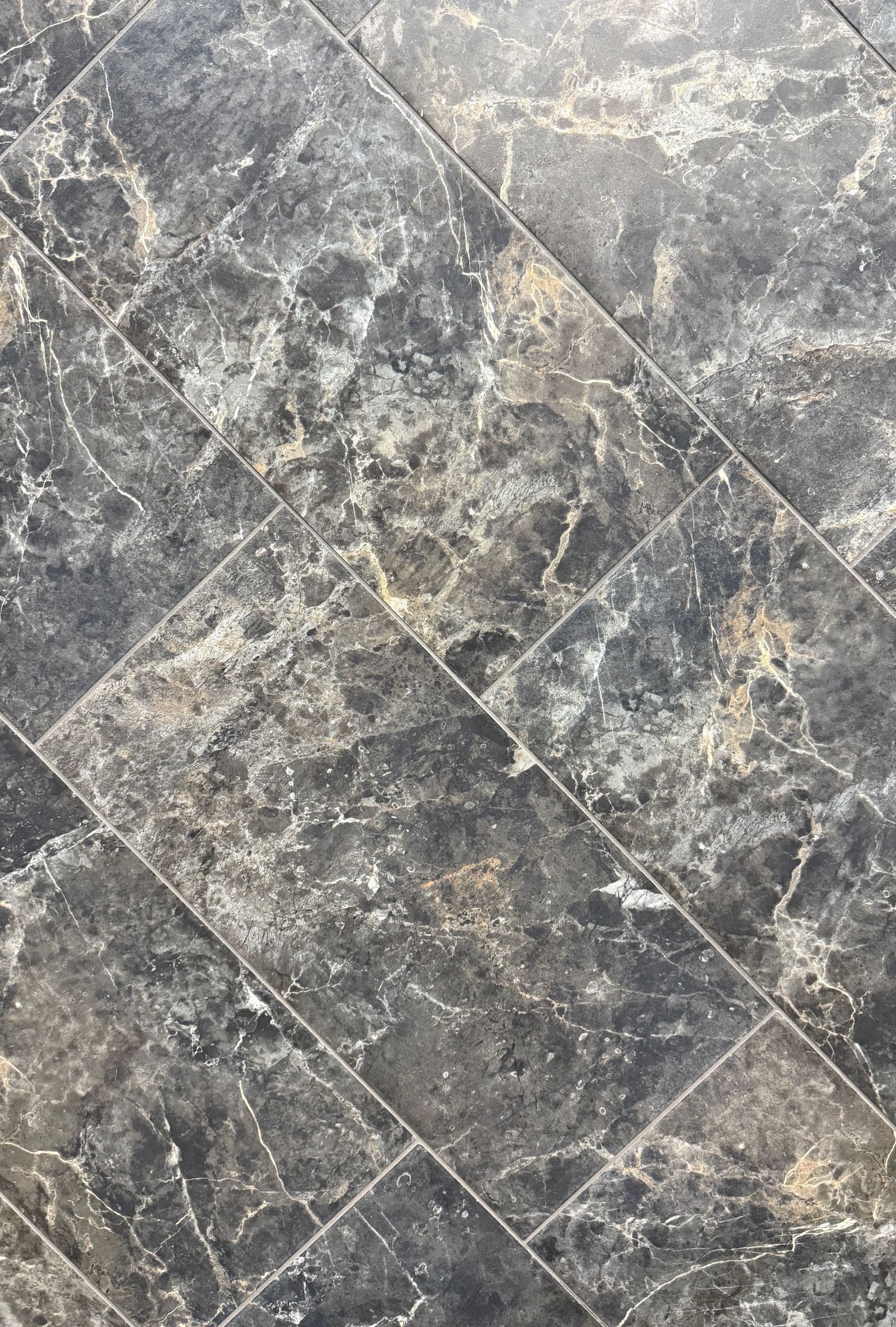 A close up of a gray marble tile floor.
