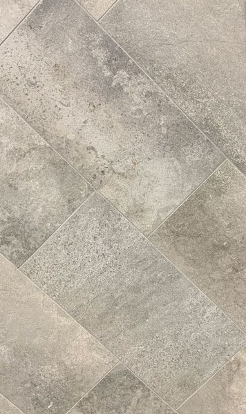 A close up of a gray tile floor.