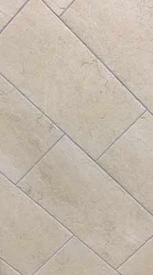 A close up of a tile floor with a diagonal pattern.