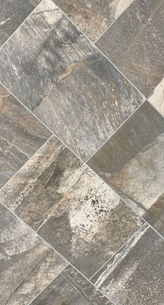 A close up of a tile floor with a checkered pattern.