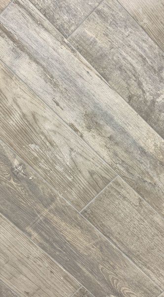 A close up of a gray tile floor that looks like wood.