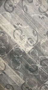 A close up of a wooden floor with a pattern on it.