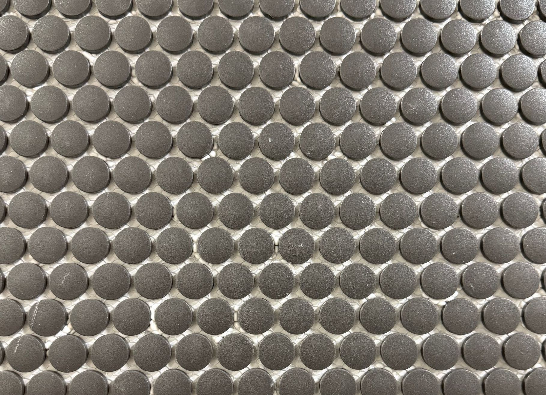 A close up of a mosaic tile with circles on it