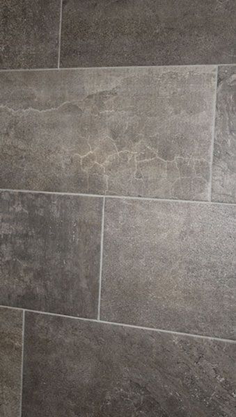 A close up of a gray tile floor.