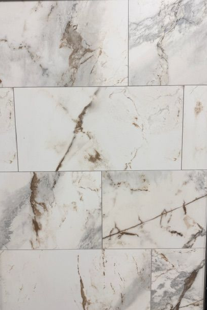 A close up of a gray tile floor with a diagonal pattern.