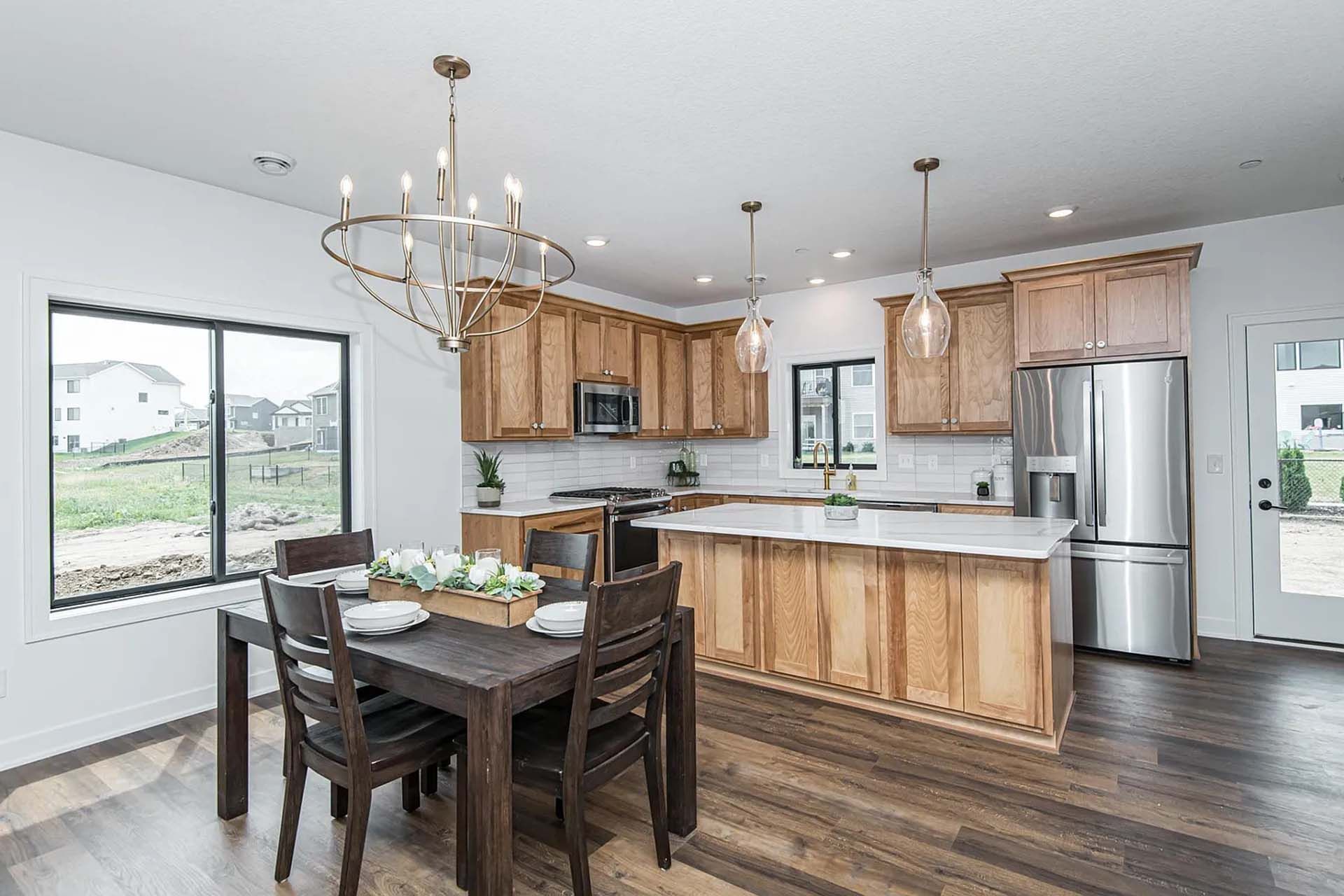 There is a dining table and chairs in the kitchen.