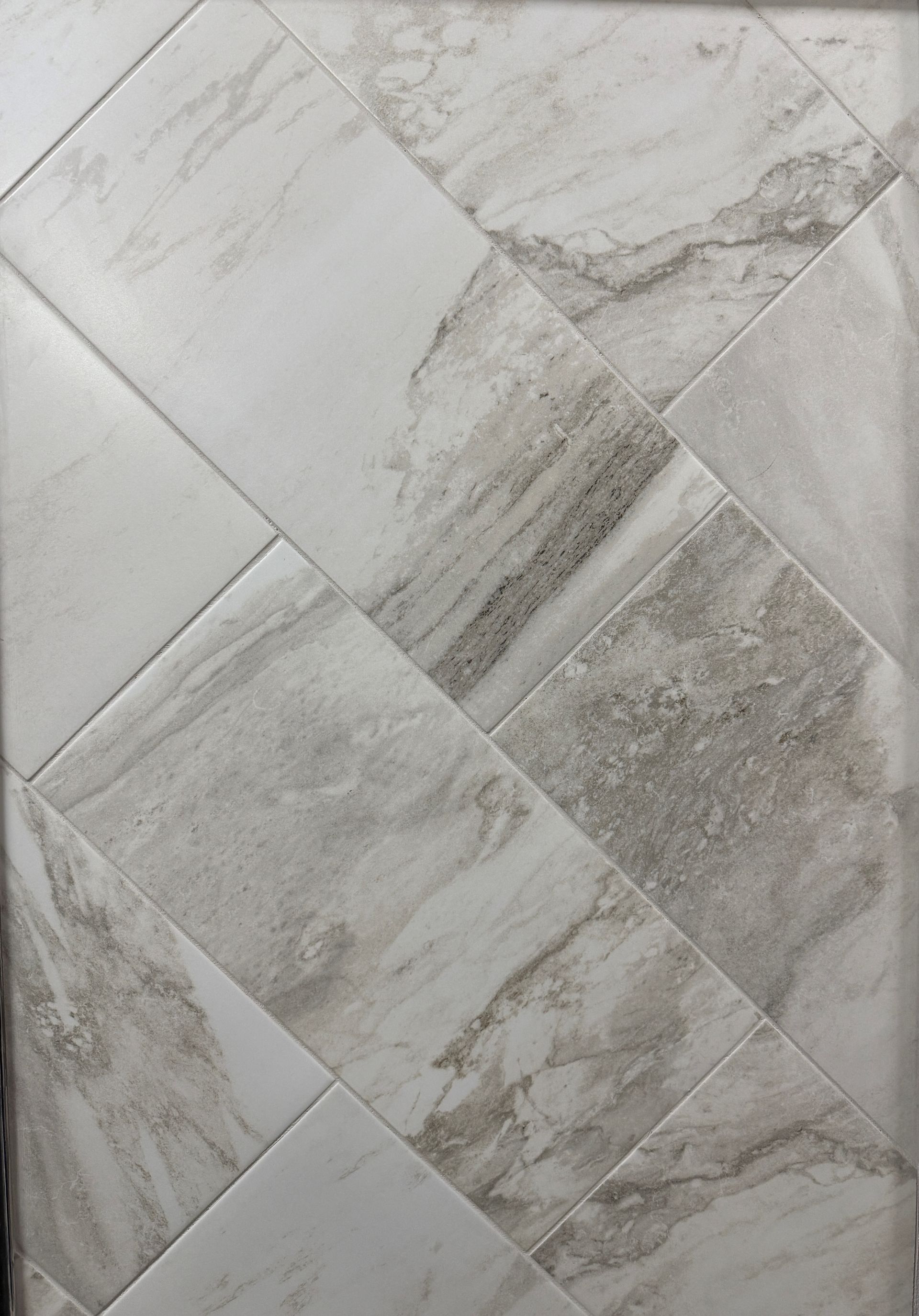 A close up of a white marble tile floor.