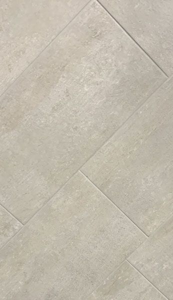 A close up of a tile floor with a diagonal pattern.