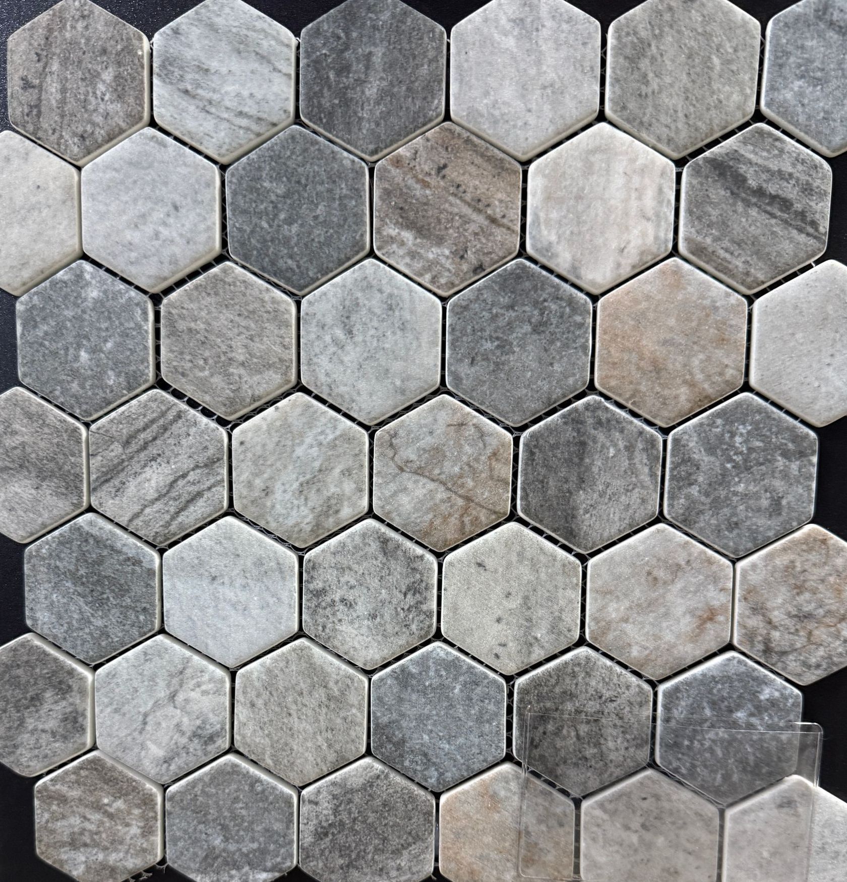 A close up of a hexagonal tile pattern on a black surface.