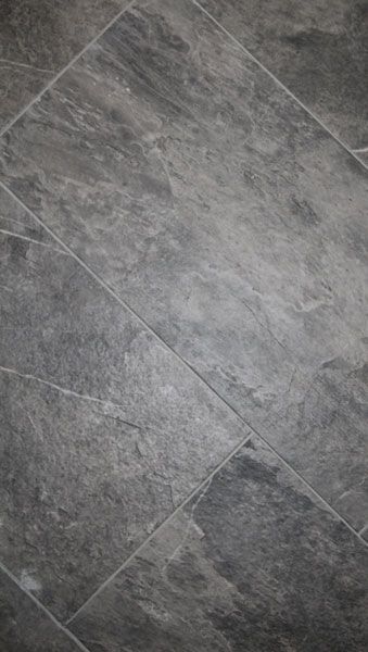 A close up of a gray tile floor.