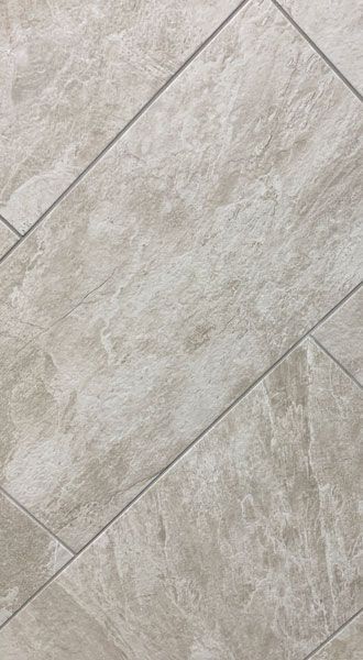 A close up of a tile floor with a marble texture.