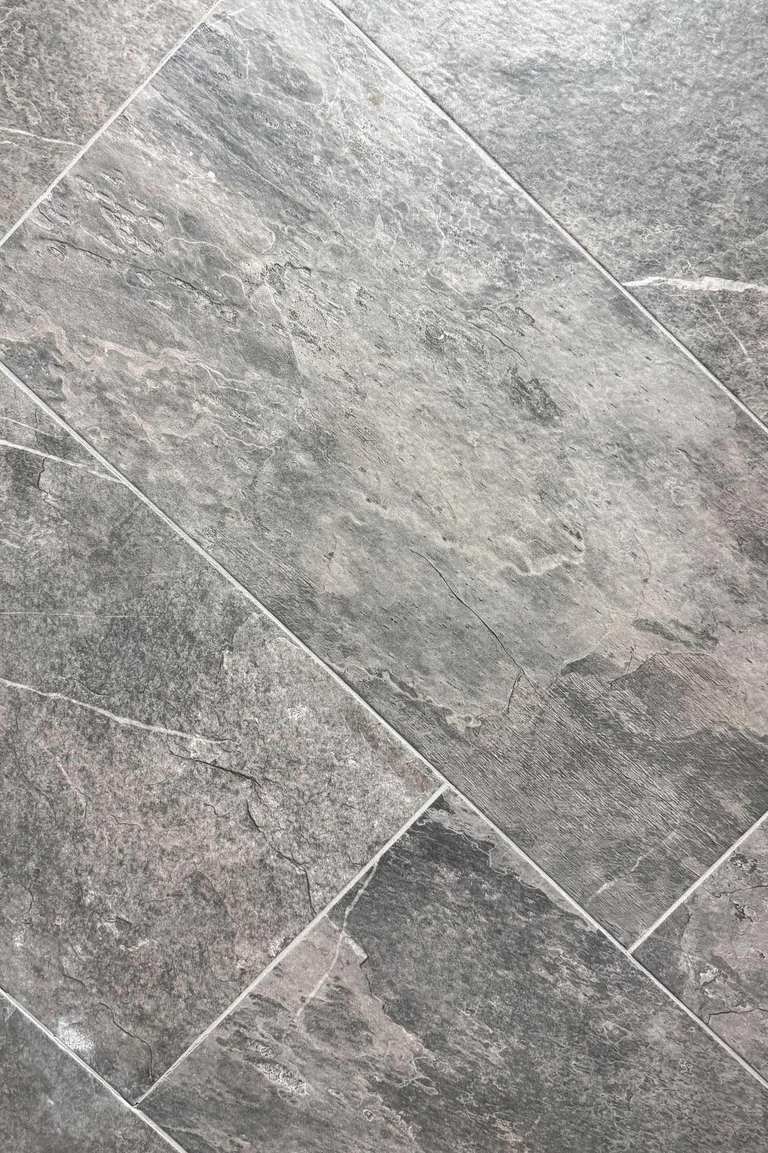 A close up of a gray tile floor.