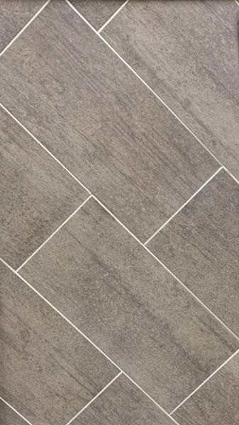 A close up of a gray tile floor with white grout.