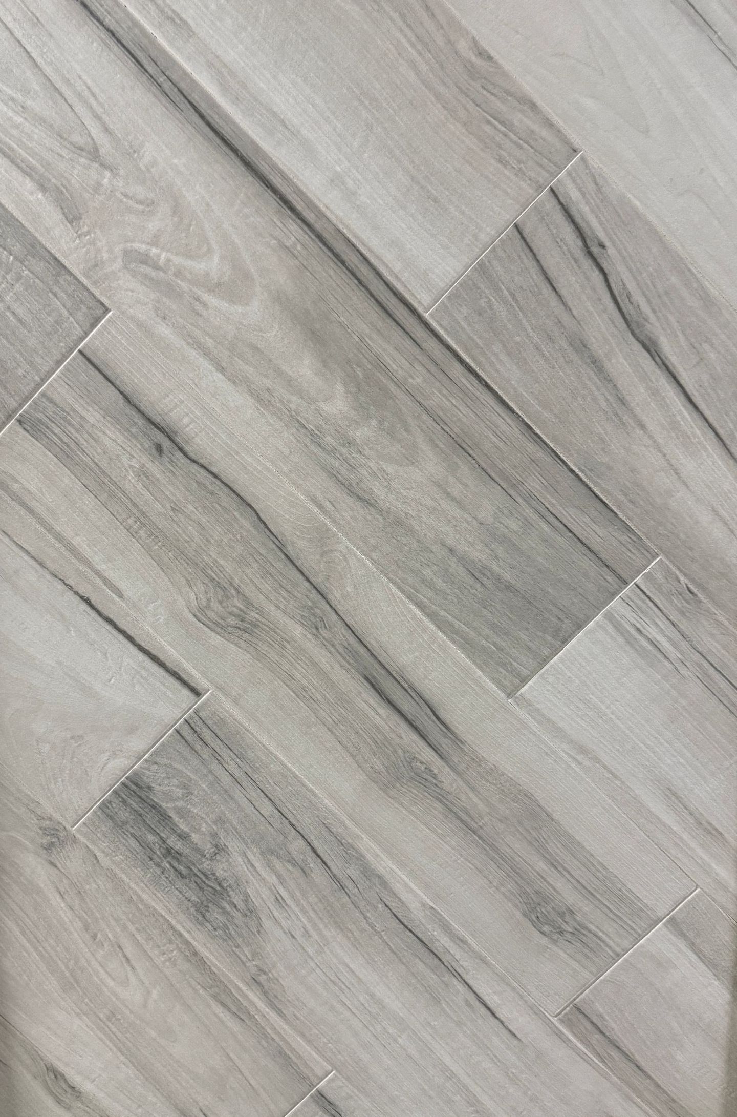 A tile that looks like wood is sitting on a table.