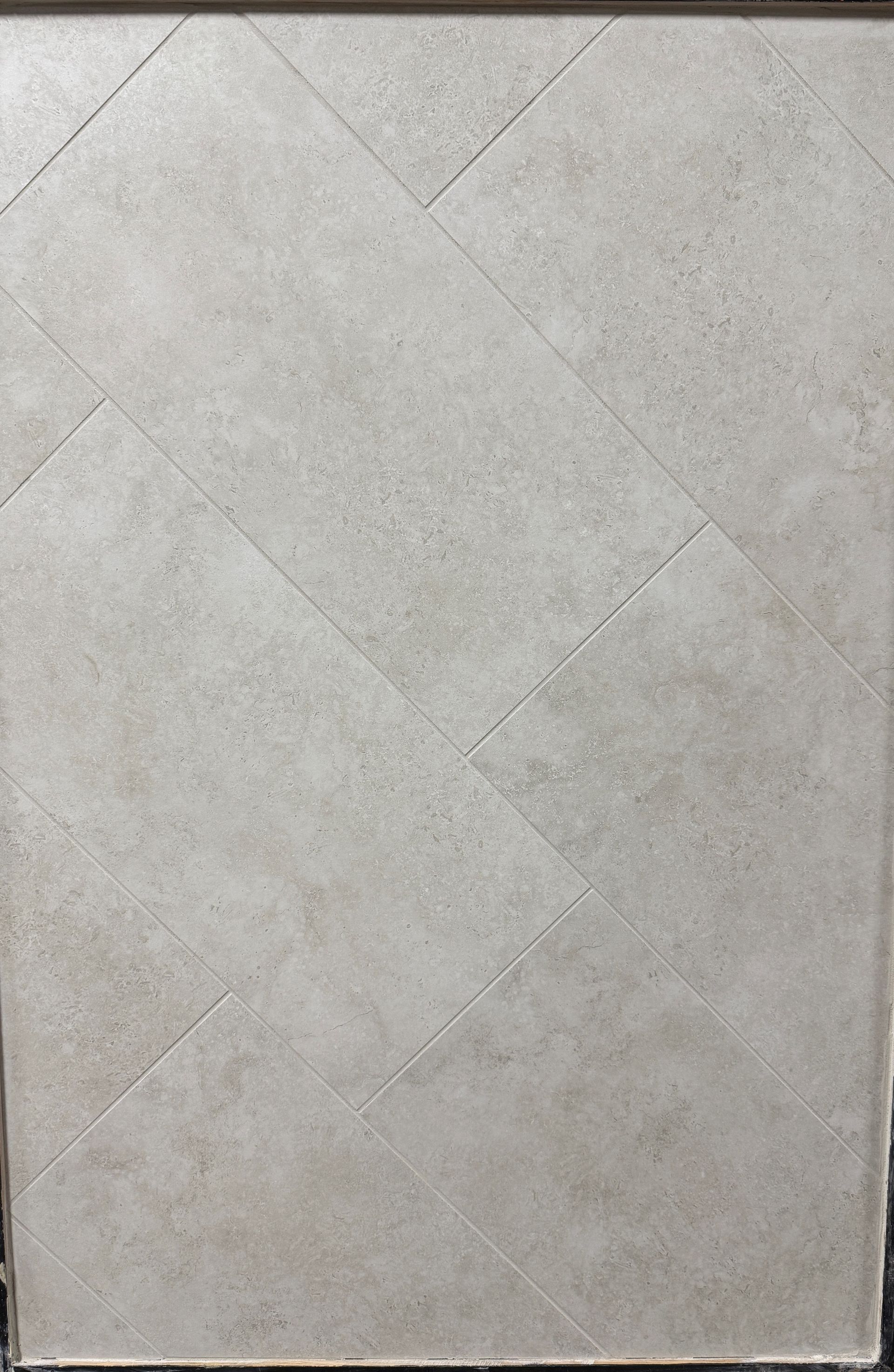 A close up of a tile floor with a diagonal pattern.