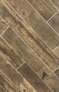 A close up of a tile floor that looks like wood.