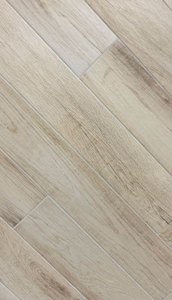 A close up of a white tile floor that looks like wood.