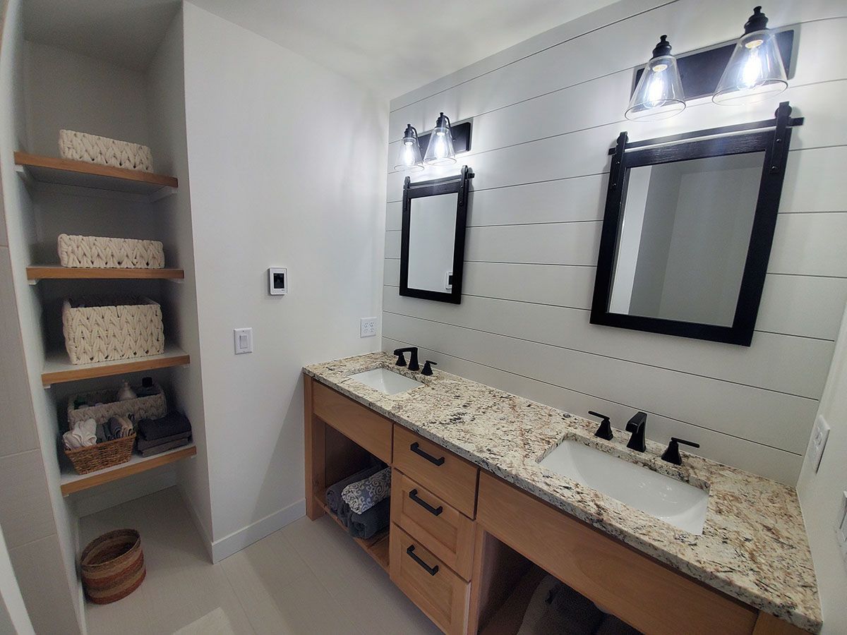 A bathroom with two sinks and two mirrors.