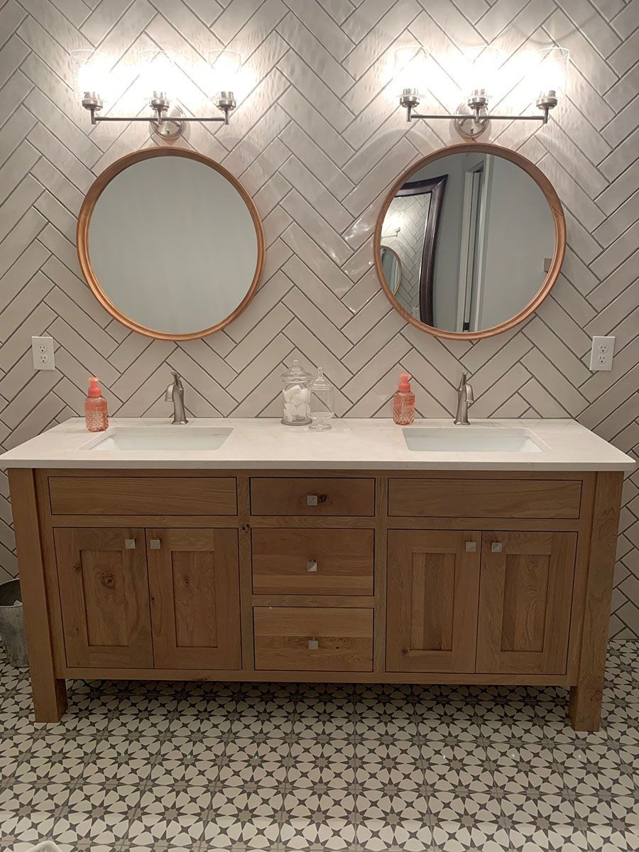 A bathroom with two sinks and two mirrors.