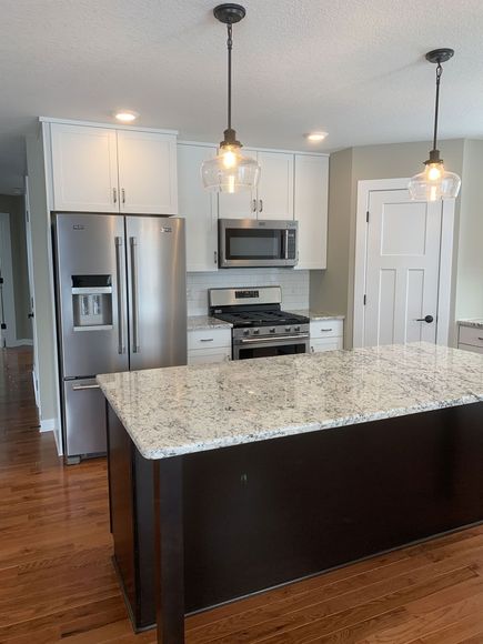 A kitchen with stainless steel appliances and granite counter tops