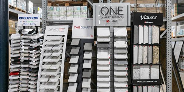 Displays of tile samples in a store, with brand signs like