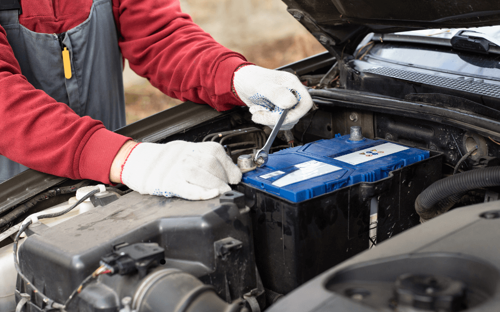 a mechanic replacing a car battery