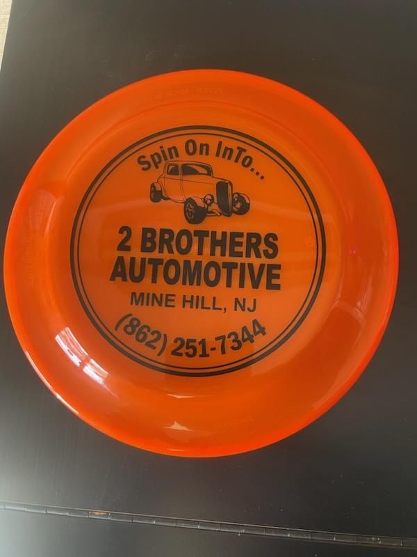 An orange frisbee from 2 brothers automotive mine hill nj