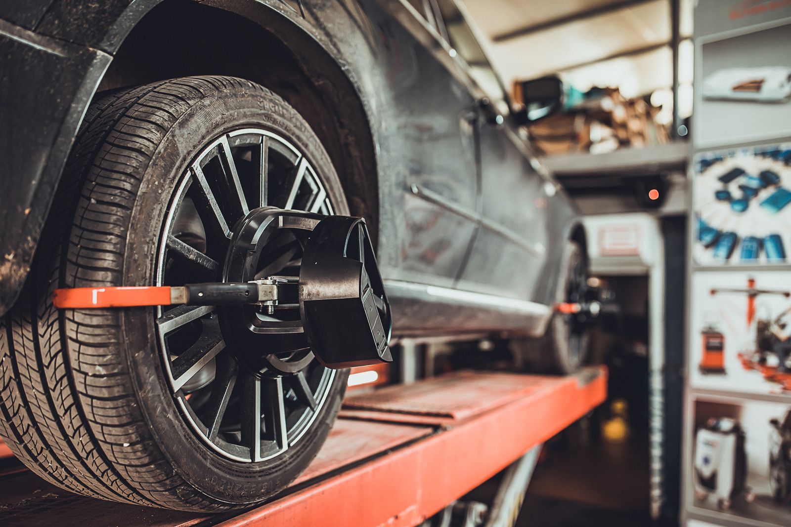 A car is being balanced on a machine in a garage.