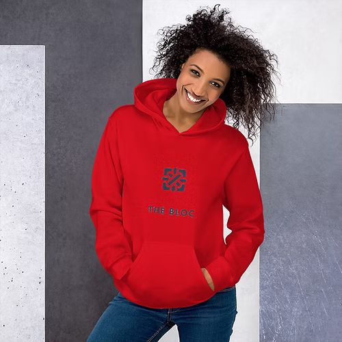 A woman is wearing a red hoodie and smiling.