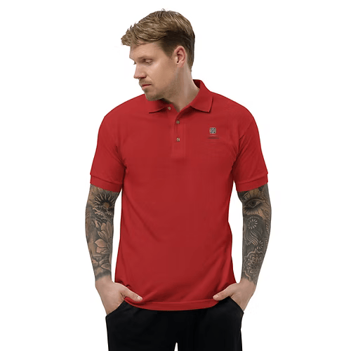 A man with a tattoo on his arm is wearing a red polo shirt.