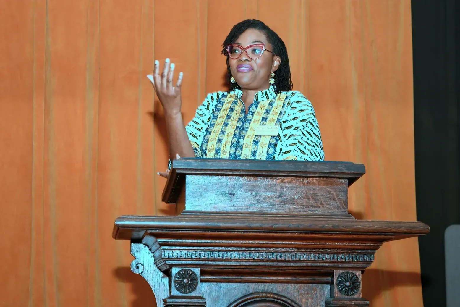 A woman is standing at a podium giving a speech.