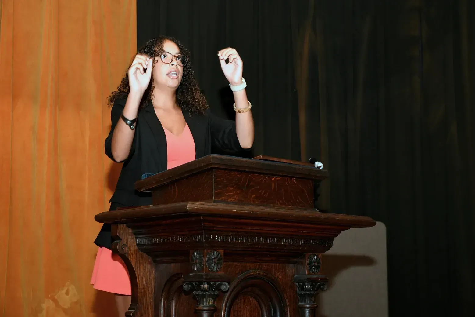 A woman is standing at a podium giving a speech.