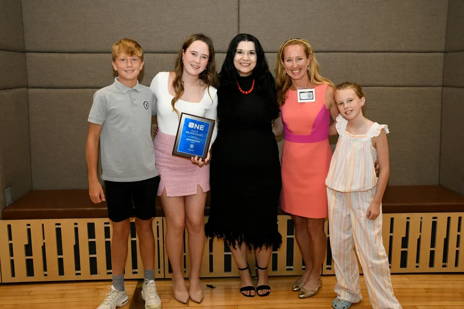 A group of people standing next to each other holding a plaque.