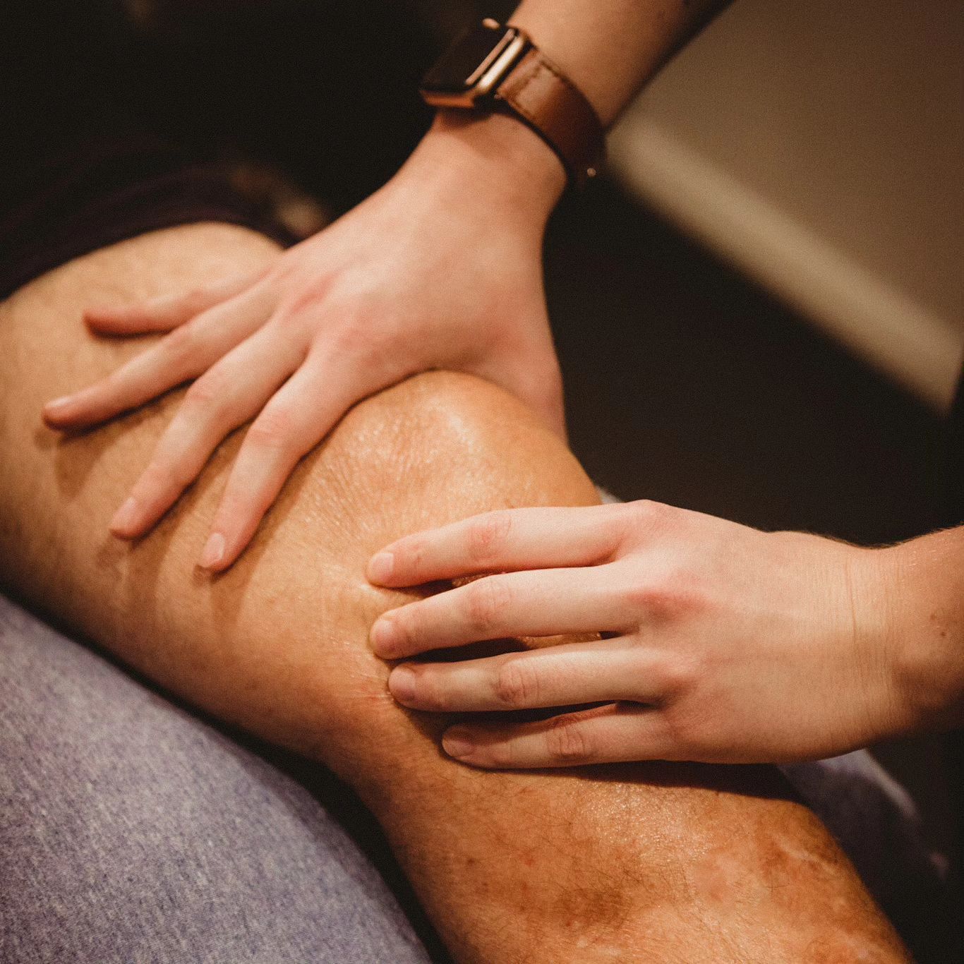 Hands Examining a Person's Knee — Forerunner Physio In Taree, NSW