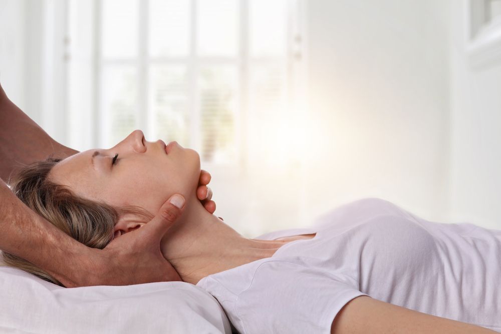Person Receiving Neck Manipulation in a Bright Room — Forerunner Physio In Taree, NSW