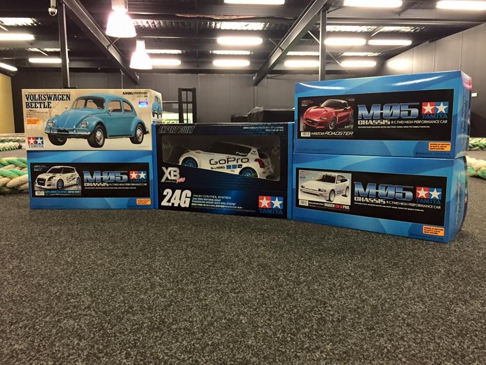 Boxes Of Model Cars On A Grey Carpet, Under Ceiling Lights — Midtown Hobbies In Lismore, NSW