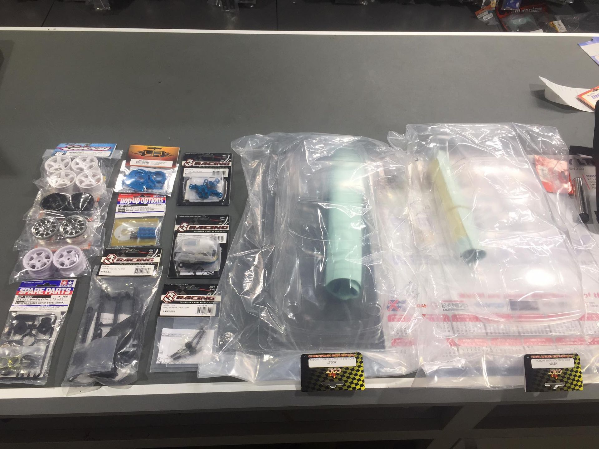 Various Small RC Car Parts In Packages On A Table — Midtown Hobbies In Lismore, NSW