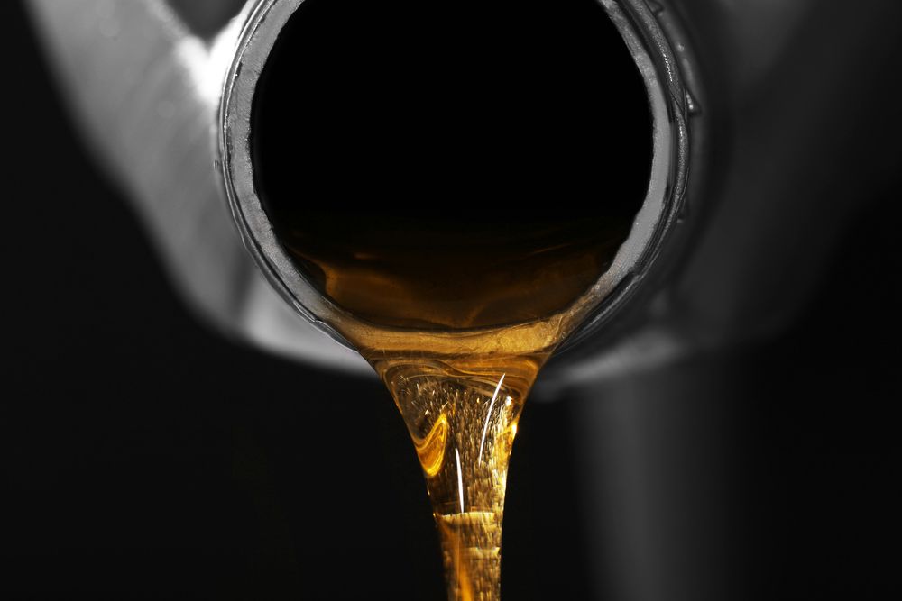 Oil Pouring From A Metal Pipe, Showing A Stream Of Amber Liquid — Midtown Hobbies In Lismore, NSW
