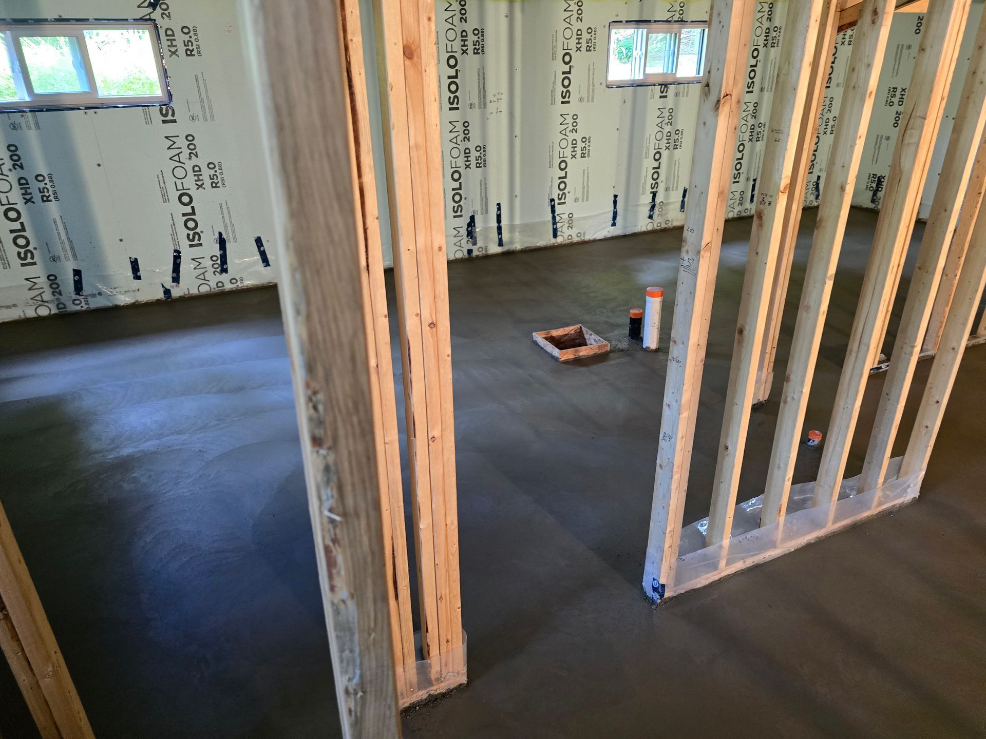 Une pièce dans une maison en construction avec un sol en béton.