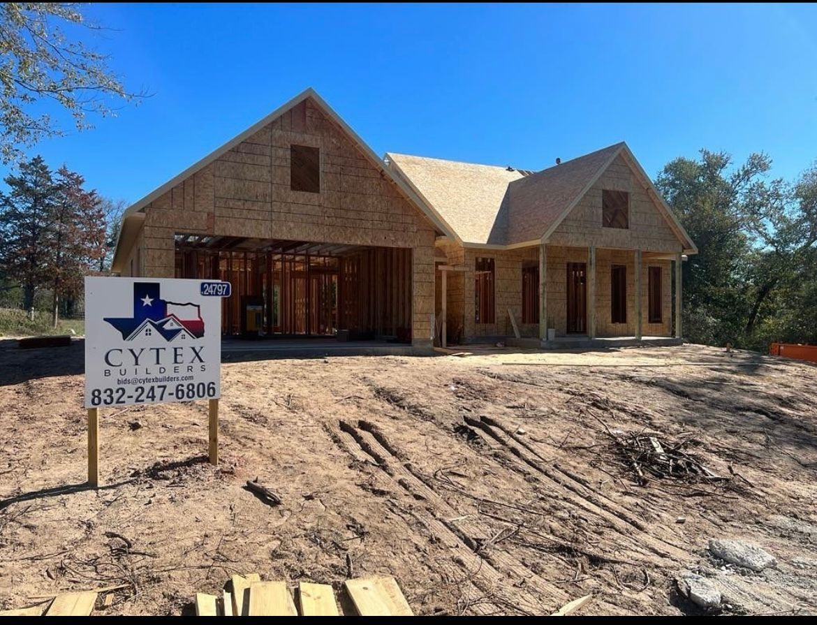 A house that is being built with a sign in front of it