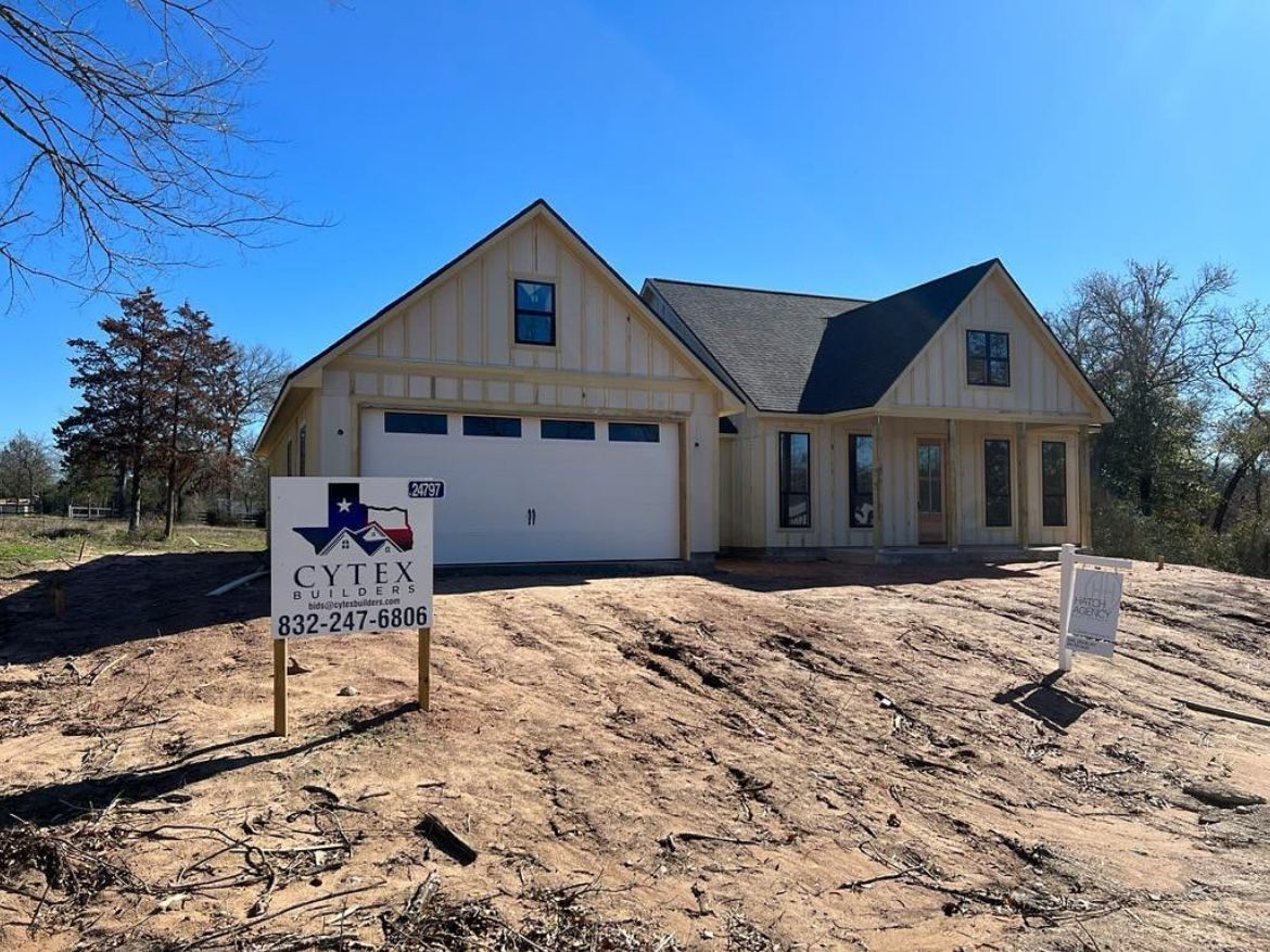 A house with a for sale sign in front of it