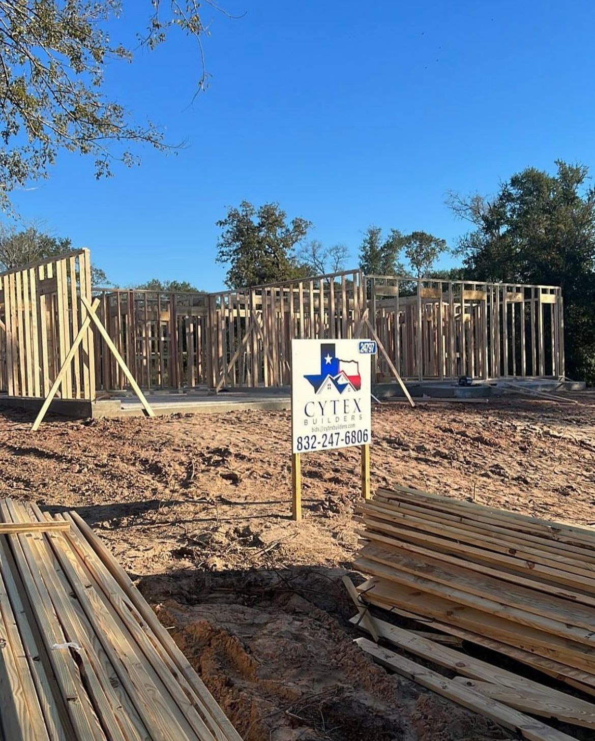 A house is being built in texas and there is a sign in the dirt.