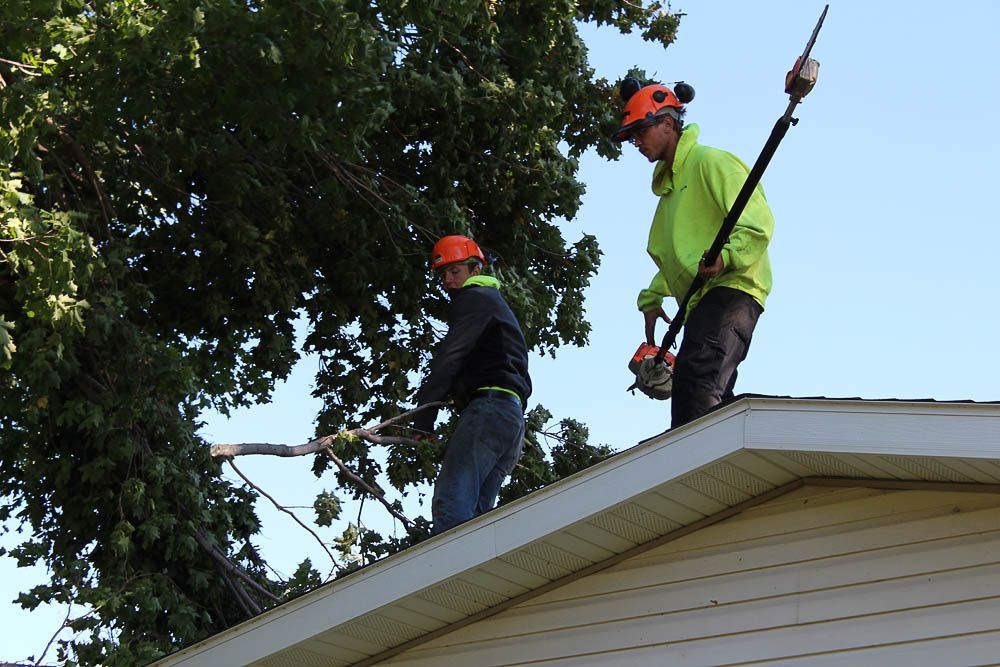 Two men are working on the roof of a house