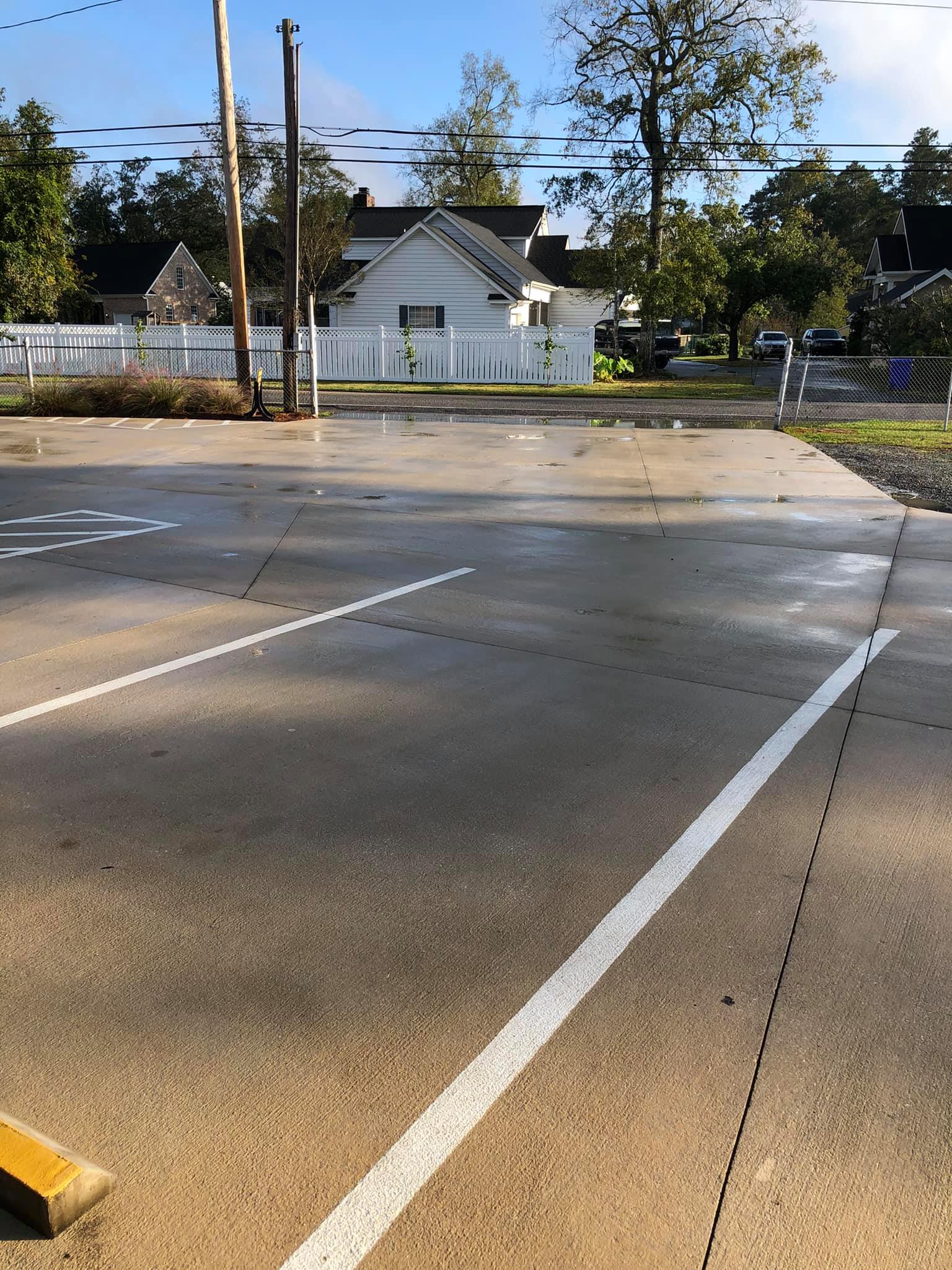 A road with a white line on it and a yellow curb.