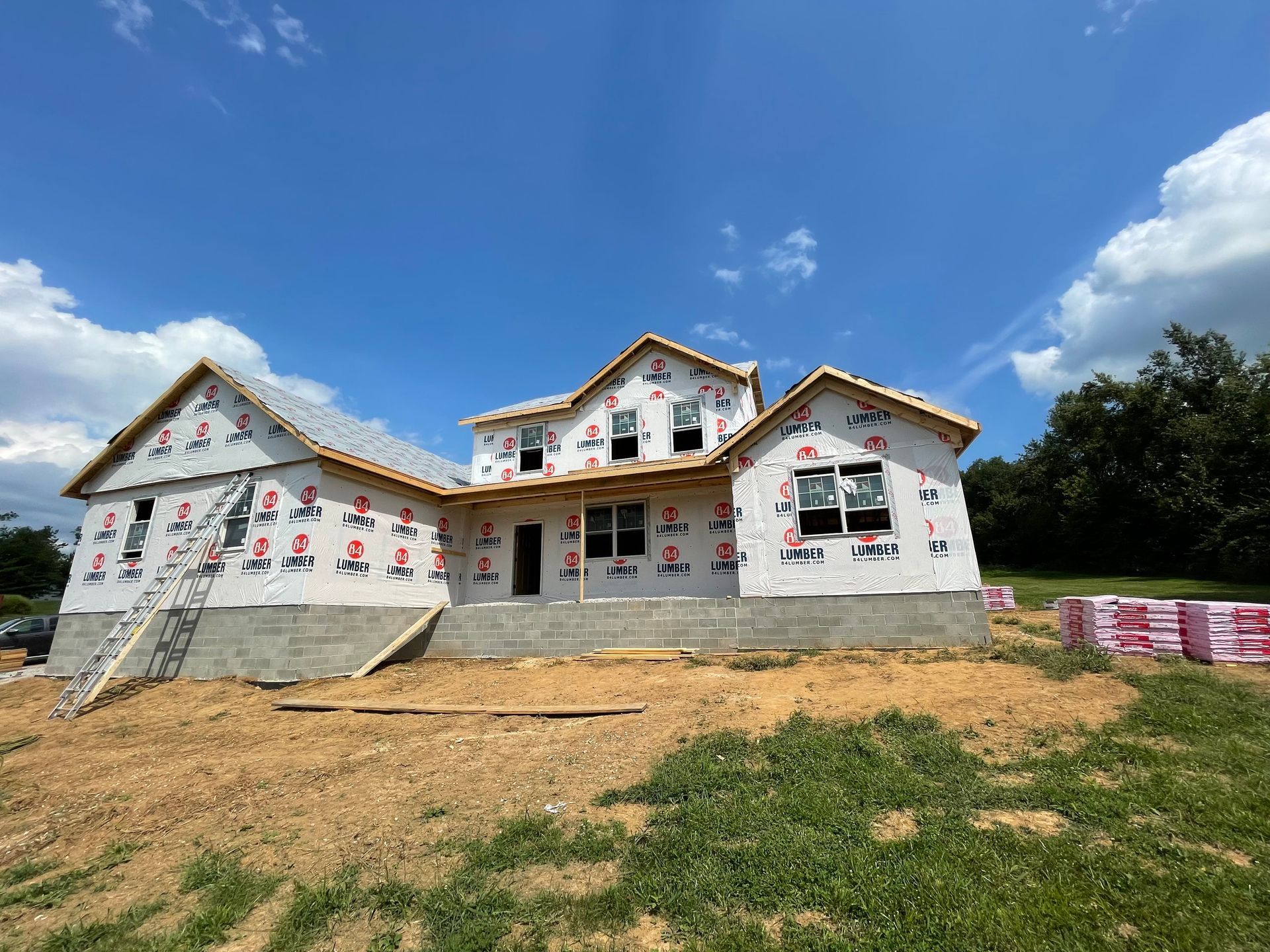 A house is being built in the middle of a field.
