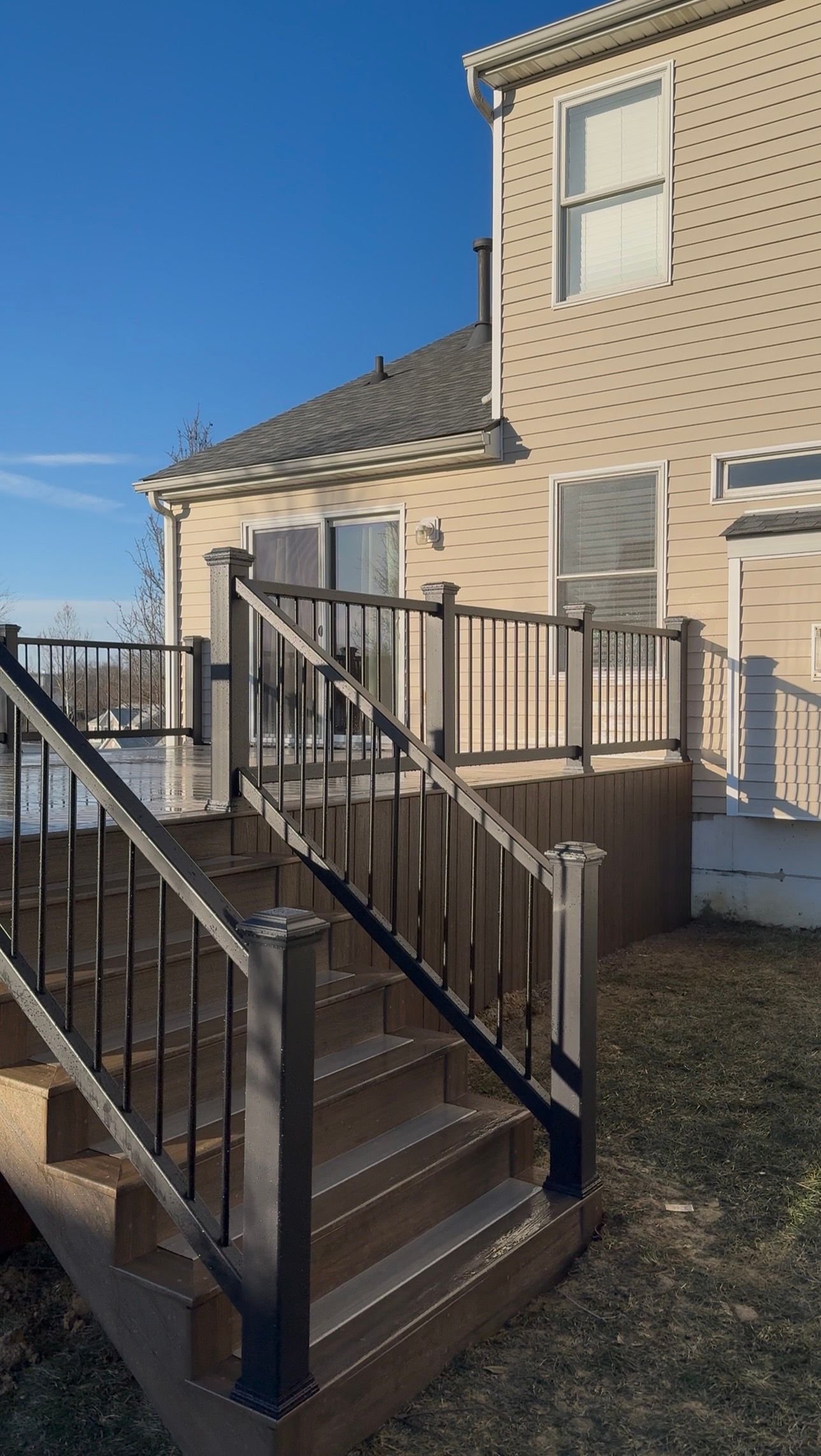 A wooden house with stairs leading up to it